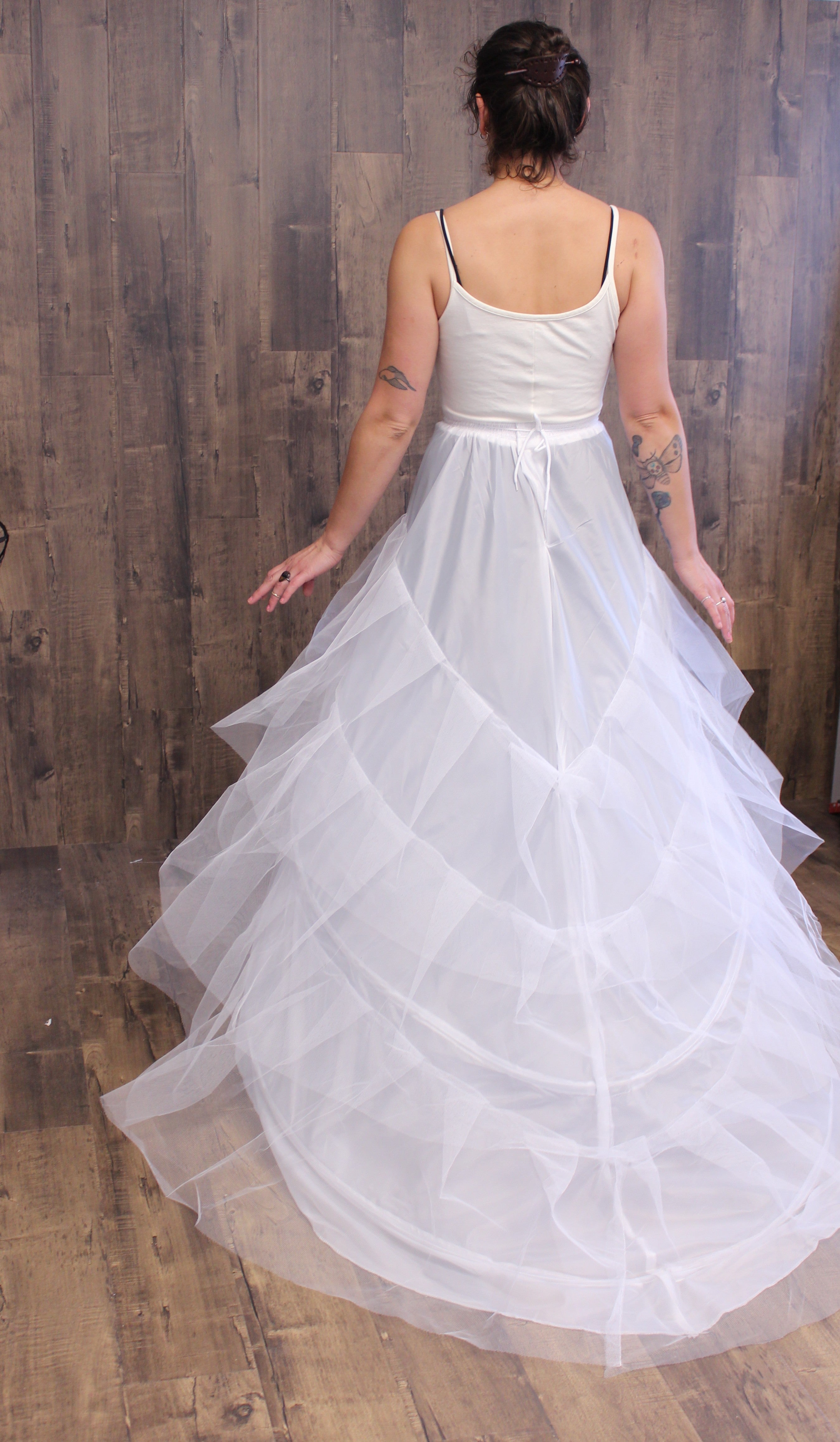 Model wearing a n elliptical cage crinoline, view from the back