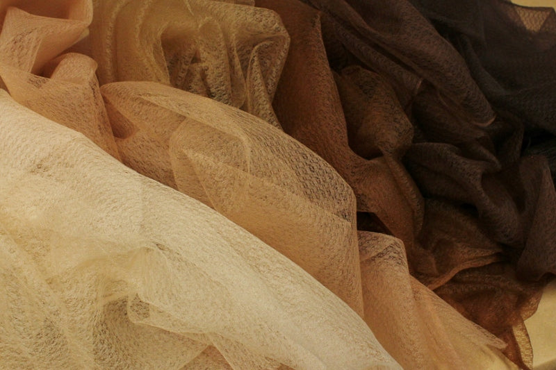 All our shades of soufle fabric in a pile.